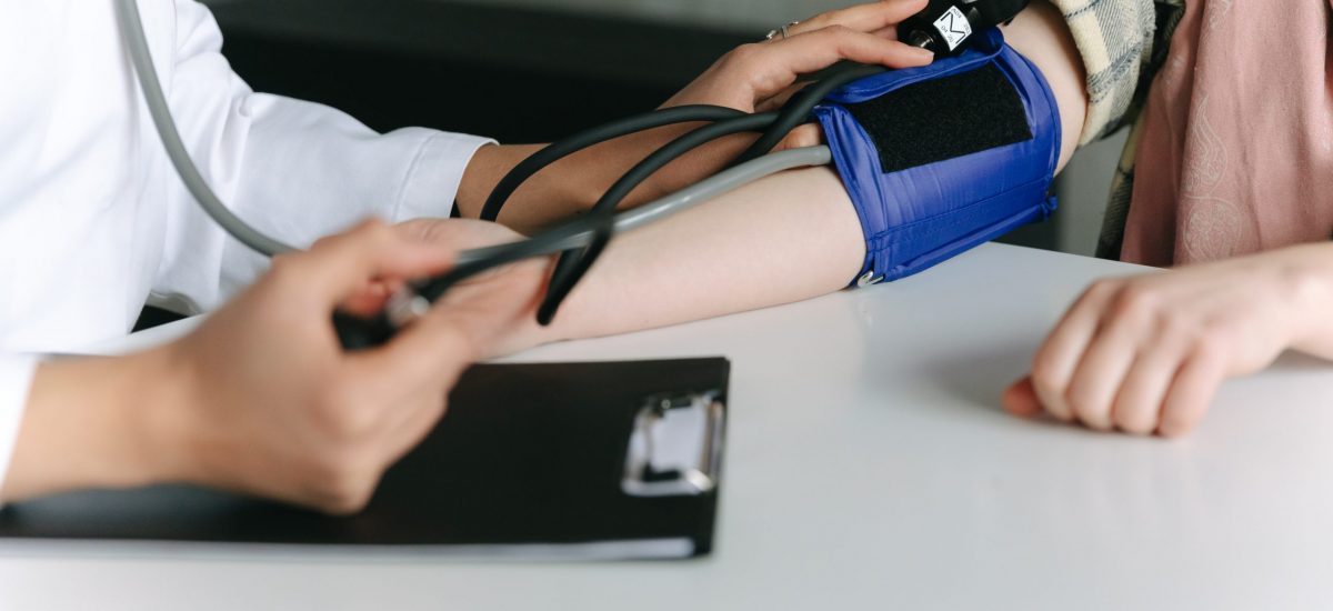 a medical professional takes blood pressure
